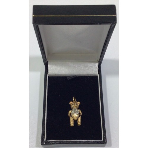 292 - A 9ct gold articulated bear charm, with ruby eyes and small diamonds set to waistcoat, 21mm tall, gr... 