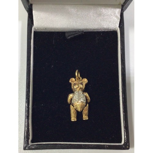 292 - A 9ct gold articulated bear charm, with ruby eyes and small diamonds set to waistcoat, 21mm tall, gr... 