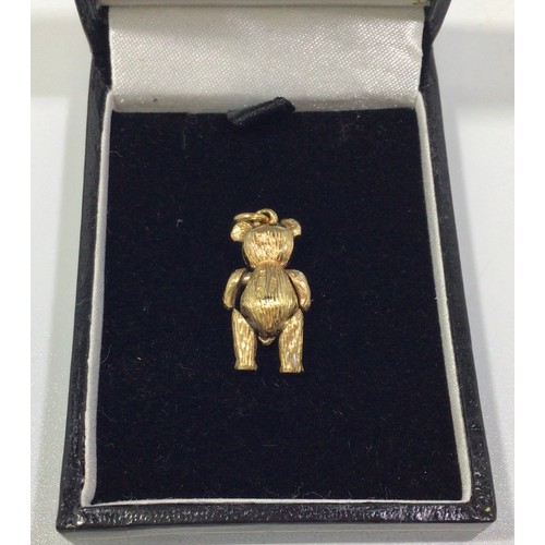 292 - A 9ct gold articulated bear charm, with ruby eyes and small diamonds set to waistcoat, 21mm tall, gr... 