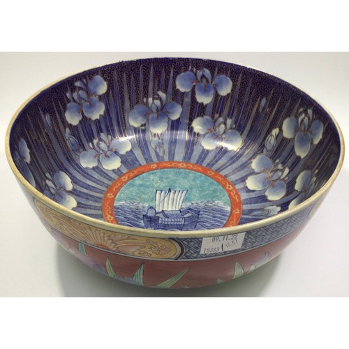 52 - A large Oriental pottery bowl, decorated in polychrome enamels with floral designs, 31cm diameter