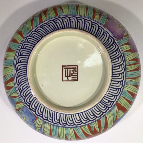 52 - A large Oriental pottery bowl, decorated in polychrome enamels with floral designs, 31cm diameter