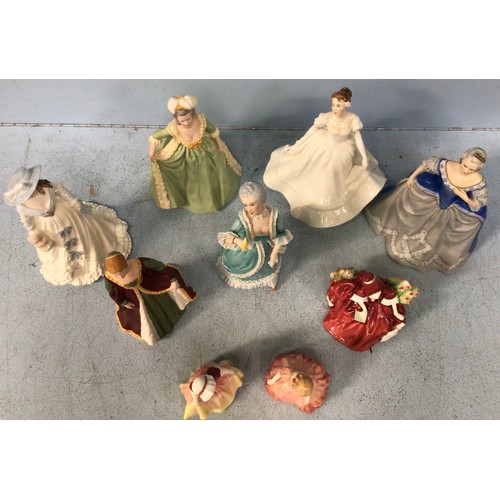 28 - Nine various hand-painted ceramic figures of ladies and girls in decorative gowns, including a Coalp... 