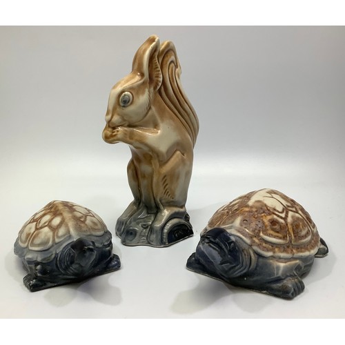 108 - Two various Langley Pottery tortoises and a squirrel, with brown and blues glazes, 1931-39, designed... 