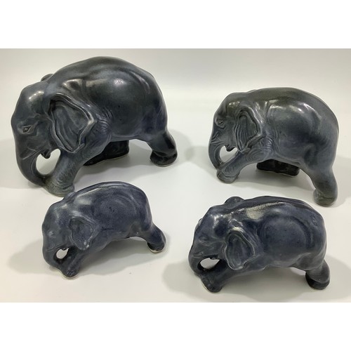 109 - Four graduated Langley pottery blue glazed elephants, designed by Frederick Braddon, 1931-39, 13cm -... 