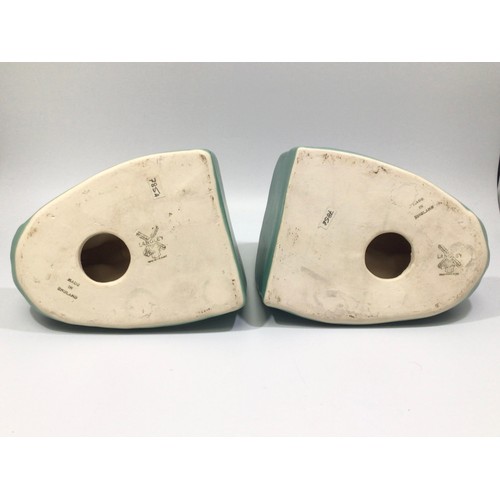 113 - A pair of green-glazed Langley Pottery bookends modelled as dolphins on wave crests, designed by Fra... 