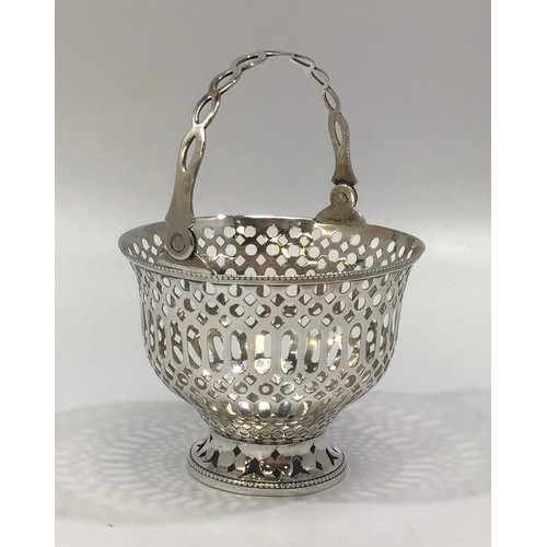 167 - A silver sugar basket by Barker Brothers, the entirety with pierced decoration and hinged handle, wi... 