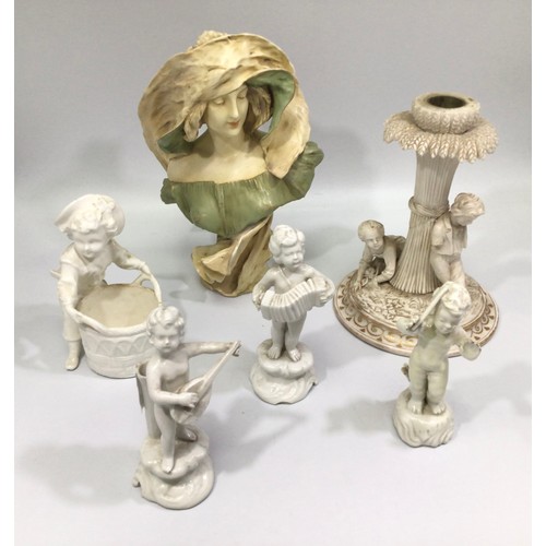 23 - Three white German porcelain musical putti on scrolled bases, with an accordion, flute and mandolin,... 