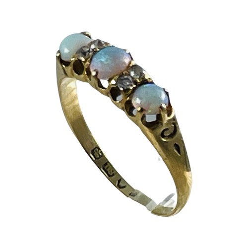 261 - An 18ct yellow gold opal and diamond ring, claw set with three opals and four small diamonds, hallma... 