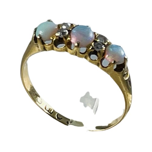 261 - An 18ct yellow gold opal and diamond ring, claw set with three opals and four small diamonds, hallma... 