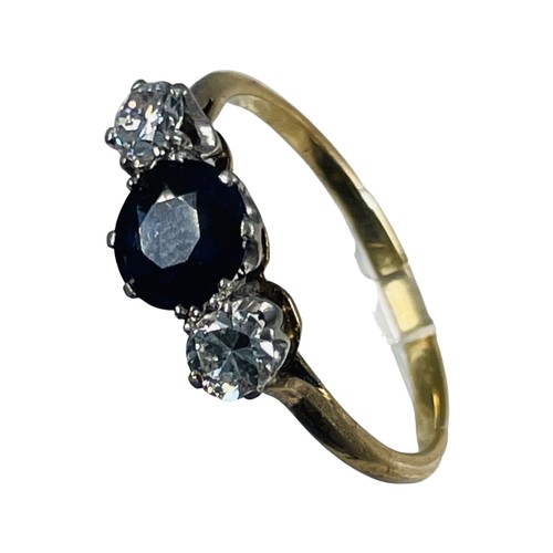 264 - An 18ct gold sapphire and diamond ring, set with a round dark blue sapphire to the centre, with a ro... 