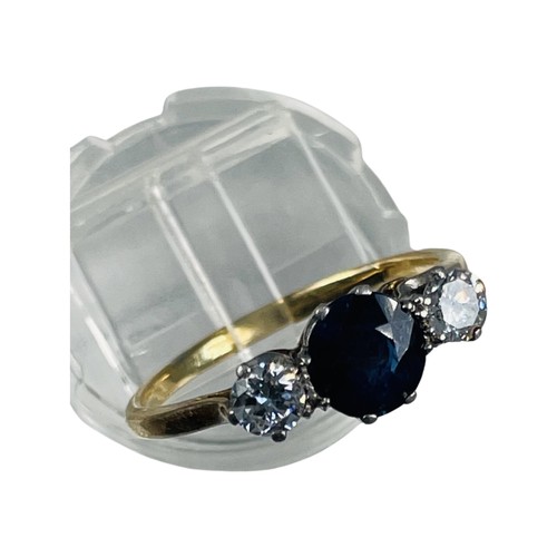 264 - An 18ct gold sapphire and diamond ring, set with a round dark blue sapphire to the centre, with a ro... 