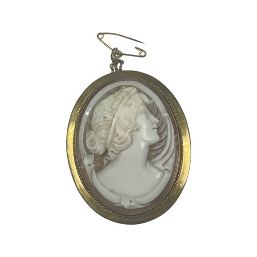 300 - A 9ct gold large oval cameo brooch, 40mm x 30mm, with safety chain, weighs 11.8 grams.