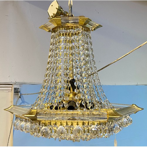 617 - A chandelier of hexagonal baluster form with cut glass droplets suspended from plastic supports, app... 