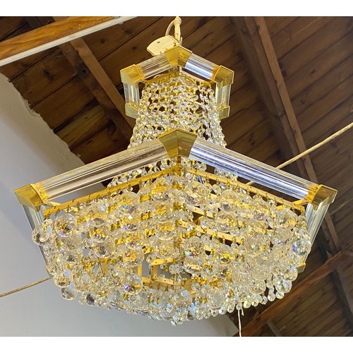 617 - A chandelier of hexagonal baluster form with cut glass droplets suspended from plastic supports, app... 