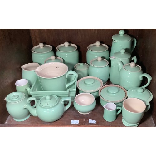 152 - A quantity of Langley Mill pottery 'Creamline' kitchen wares in 'Court Green,' including tea and cof... 