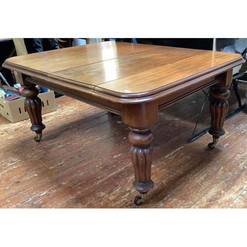 621 - A very large rectangular extending mahogany dining table with stepped rounded edges and corners rais... 