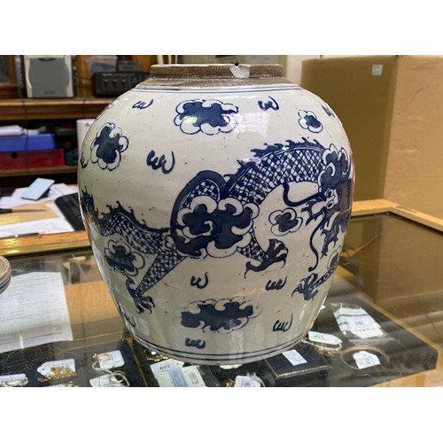 49 - A large Chinese porcelain ginger jar and cover painted in underglaze cobalt blue with dragons amidst... 