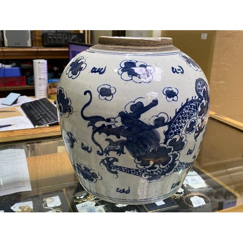 49 - A large Chinese porcelain ginger jar and cover painted in underglaze cobalt blue with dragons amidst... 