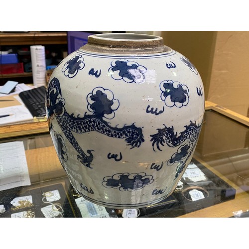 49 - A large Chinese porcelain ginger jar and cover painted in underglaze cobalt blue with dragons amidst... 