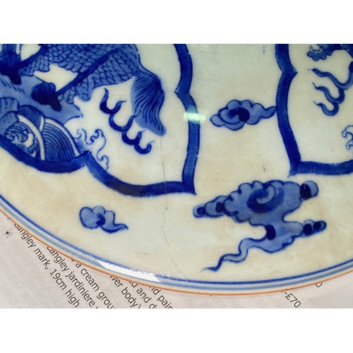 53 - A large Chinese porcelain cylindrical pot and cover painted in cobalt blue with dragns, Kangxi marks... 