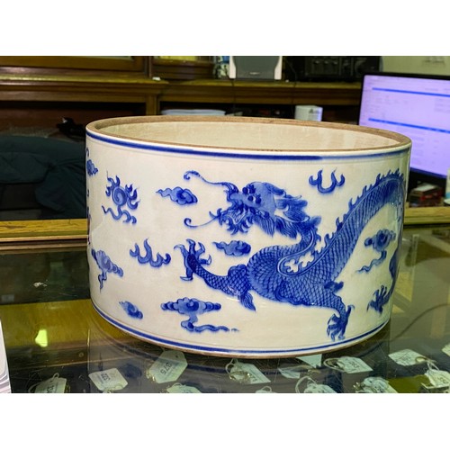 53 - A large Chinese porcelain cylindrical pot and cover painted in cobalt blue with dragns, Kangxi marks... 