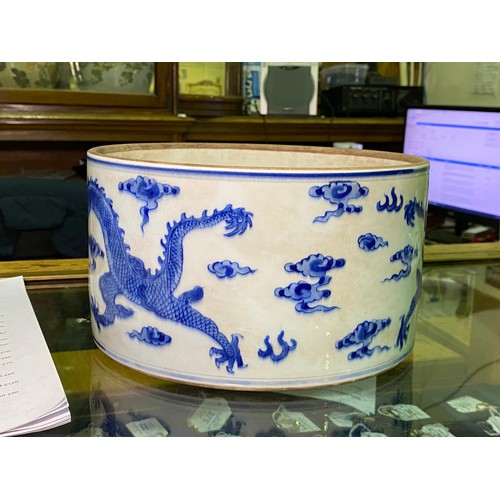 53 - A large Chinese porcelain cylindrical pot and cover painted in cobalt blue with dragns, Kangxi marks... 