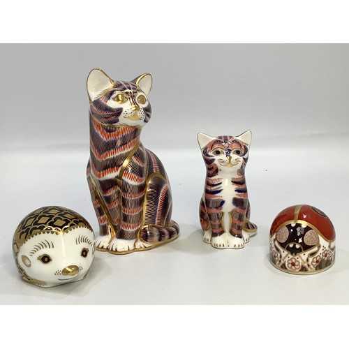 12 - Four Royal Crown Derby paperweights including ‘Aura’ the hedgehog, a ladybird and two cats, all with... 