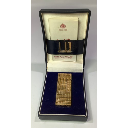 393 - A gold plated Dunhill Rollagas lighter with continuous engine turned decoration, in original box wit... 