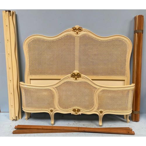 604 - A modern cream and gold painted French style king size bed with double-walled rattan back and base a... 