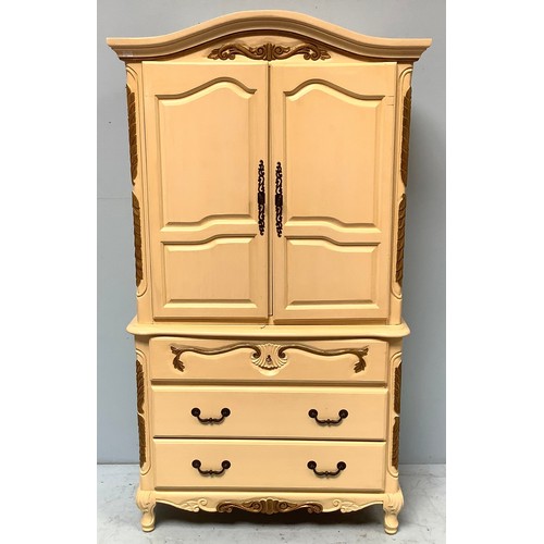 605 - A modern cream and gold painted French style two door armoire and a small linen press, converted to ... 