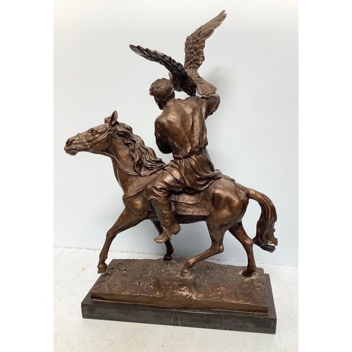 565 - A well-cast and patinated bronze figure of a mounted Arabian man with hunting hawk, unsigned, mounte... 