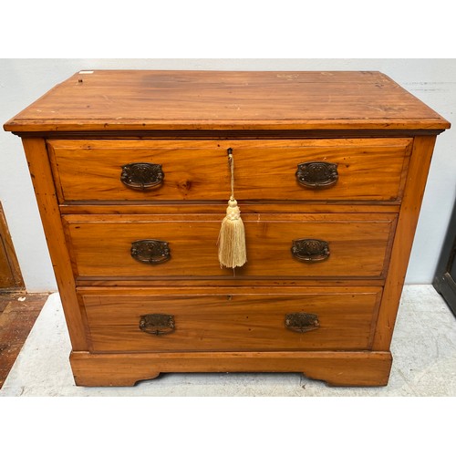 603 - An Edwardian stained walnut chest of three drawers with art nouveau period handles, raised on bracke... 