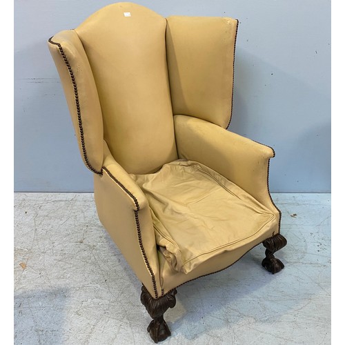 618 - A large Victorian wingback armchair upholstered in cream leather with studding to top, sides and bac... 