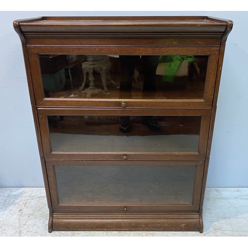 608 - A Globe Wernicke style oak stacking bookcase with three graduated sections, ‘up and over’ glass door... 