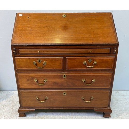 620 - A George III mahogany bureau with fall-front enclosing compartments, pigeon holes and secret compart... 