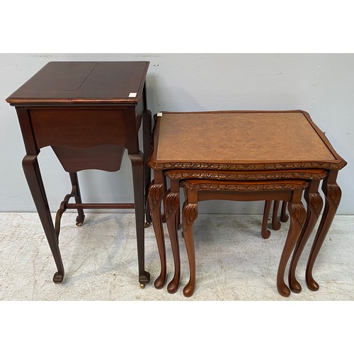 616 - An Edwardian mahogany work / sewing table with top opening to reveal compartmented interior and padd... 