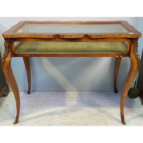 619 - A French style walnut bijouterie table with shaped top, interior lined with green velvet, raised on ... 