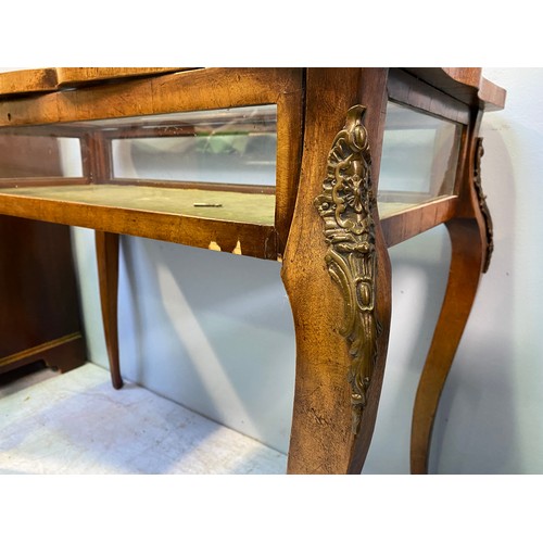 619 - A French style walnut bijouterie table with shaped top, interior lined with green velvet, raised on ... 