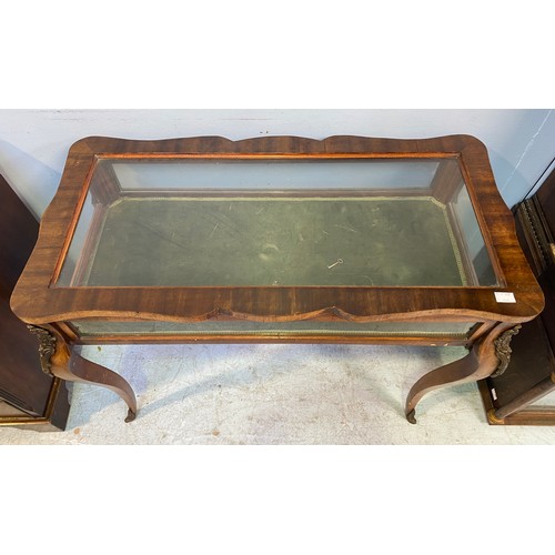 619 - A French style walnut bijouterie table with shaped top, interior lined with green velvet, raised on ... 