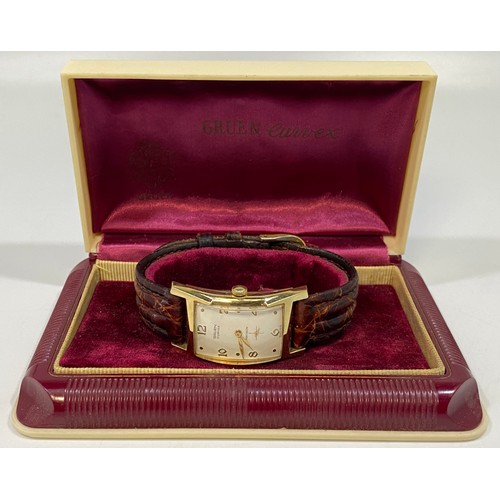 177 - A gold-plated Gruen 'Curvex' wristwatch, the curved, rectangular white dial with alternating Arabic ... 