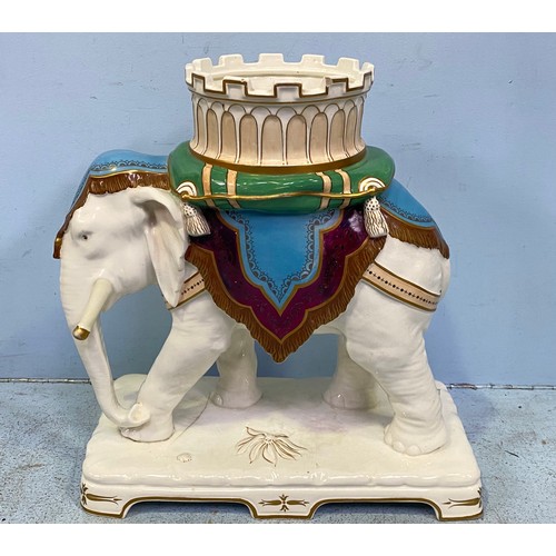 1 - A large porcelain figure of an elephant carrying a howdah on a green tasselled cushion and purple, b... 