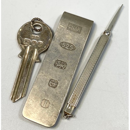 111 - Three items of silver comprising a money clip with oversized hallmarks to one side, a sterling silve... 