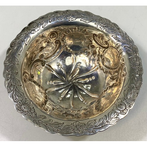 164 - A George III Irish silver sugar bowl or bon-bon of circular form with everted rim, embossed and chas... 