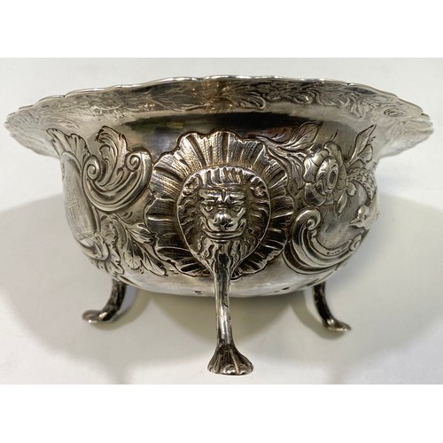 164 - A George III Irish silver sugar bowl or bon-bon of circular form with everted rim, embossed and chas... 