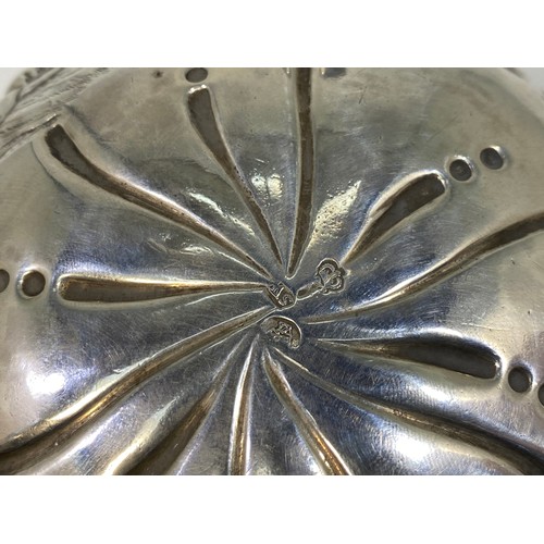 164 - A George III Irish silver sugar bowl or bon-bon of circular form with everted rim, embossed and chas... 