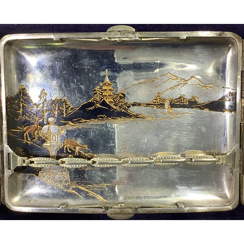 113 - A Japanese silver and niello worked cigarette case with double flip out front, engraved inside and o... 