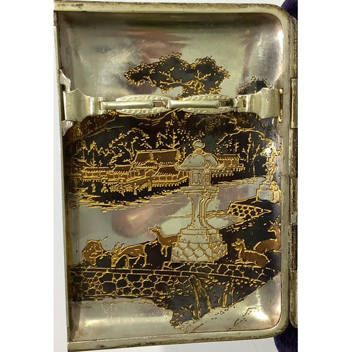 113 - A Japanese silver and niello worked cigarette case with double flip out front, engraved inside and o... 