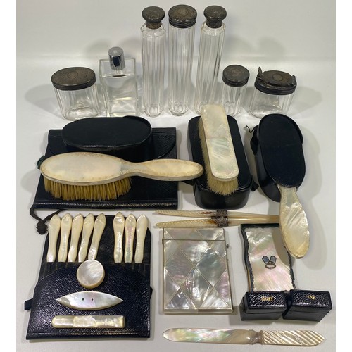 145 - A Victorian circa 1865 contents of a travelling vanity case including six silver-topped toilette jar... 