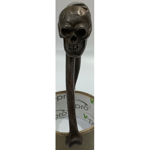 515 - A skull and crossbones nutcracker marked with monogram ‘HJB Rd 740410’, 15cm long