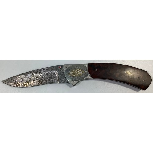 517 - A South African folding knife by John Wilmot with silver inlaid Damascus blade and wooden handle, bl... 